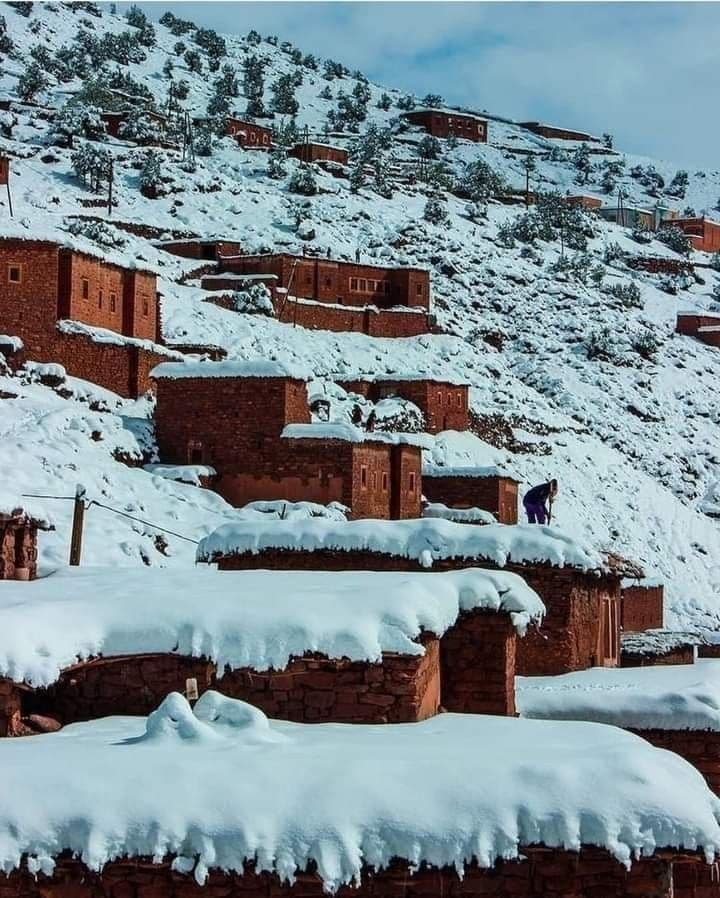 Snow-covered Berber village on a mountainside in the High Atlas — Morocco in winter